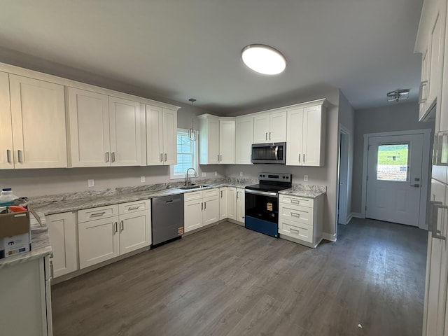 1526 2nd St, Waynesboro, VA 22980 - kitchen with appliances with stainless steel finishes, healthy amount of natural light, white cabinets, and dark wood-style floors