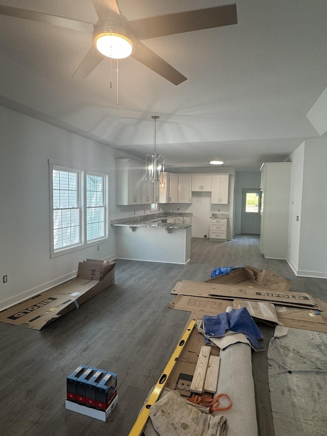 1526 2nd St, Waynesboro, VA 22980 - unfurnished living room with baseboards, wood finished floors, ceiling fan, and a chandelier