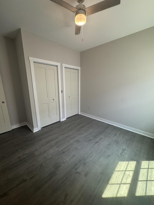 1526 2nd St, Waynesboro, VA 22980 - unfurnished bedroom featuring two closets, dark wood finished floors, and baseboards
