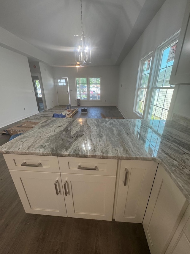 1526 2nd St, Waynesboro, VA 22980 - kitchen with open floor plan, light stone counters, a peninsula, white cabinetry, and a chandelier