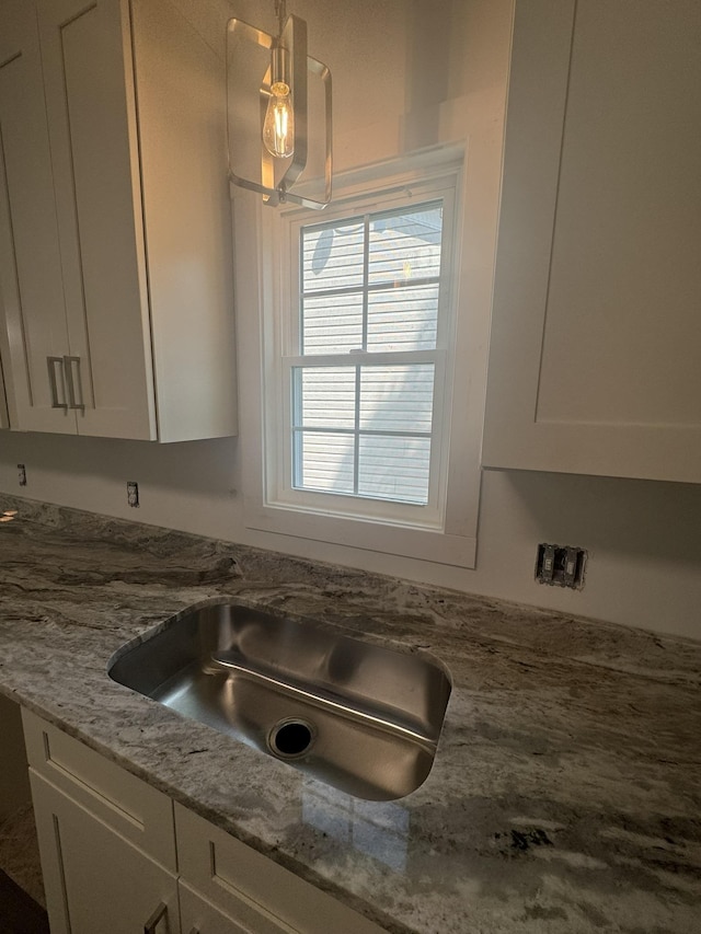 1526 2nd St, Waynesboro, VA 22980 - kitchen view of white cabinetry, light stone counters, and a sink
