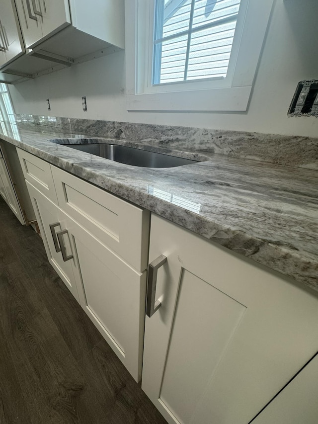 1526 2nd St, Waynesboro, VA 22980 - kitchen view of dark wood-style floors, white cabinets, and light stone counters