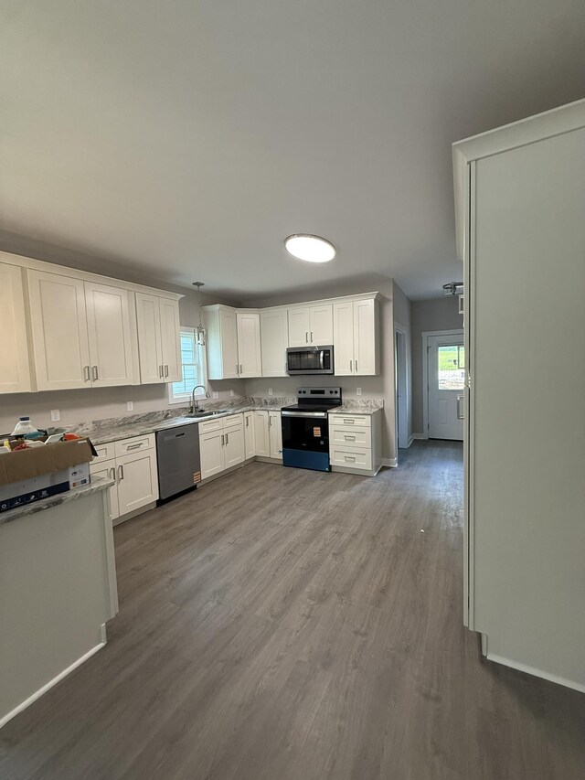 1526 2nd St, Waynesboro, VA 22980 - kitchen with stainless steel appliances, dark wood-style floors, white cabinetry, and plenty of natural light