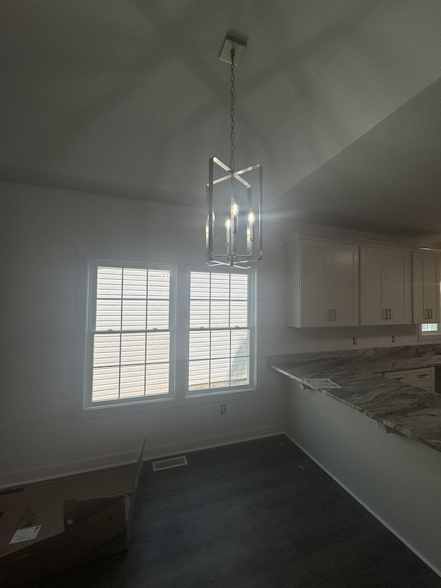 1526 2nd St, Waynesboro, VA 22980 - unfurnished dining area featuring a chandelier, lofted ceiling, dark wood-style flooring, and baseboards