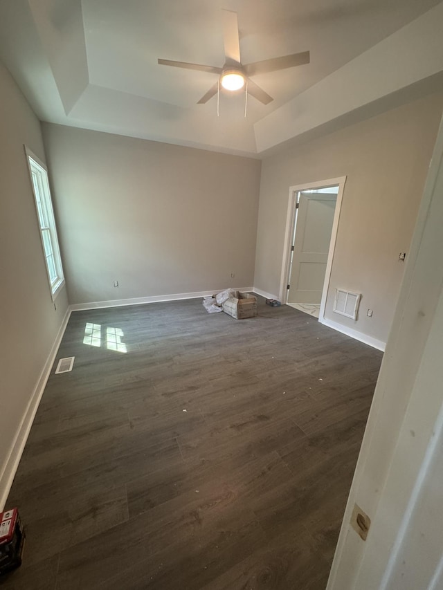 1526 2nd St, Waynesboro, VA 22980 - spare room with a tray ceiling, dark wood-type flooring, a ceiling fan, and baseboards