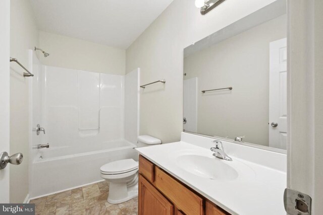 bathroom featuring toilet, vanity, and bathtub / shower combination