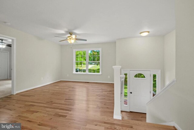 entryway with a ceiling fan, wood finished floors, and baseboards