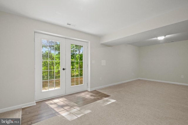 entryway featuring french doors, baseboards, and carpet flooring