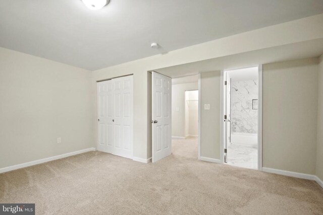 unfurnished bedroom with carpet flooring, a closet, and baseboards