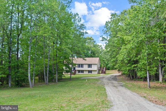 view of front of home with driveway and a front lawn