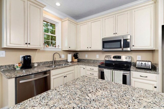 117 Villa View Dr, Staunton, VA 24401 - kitchen featuring appliances with stainless steel finishes, a sink, cream cabinetry, light stone counters, and crown molding