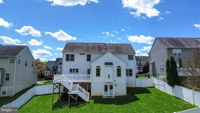 back of property featuring a deck, stairway, and a residential view