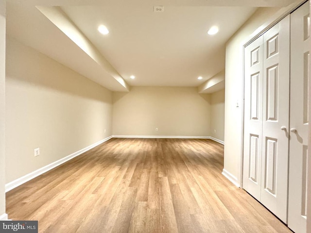 additional living space with light wood-style flooring, baseboards, and recessed lighting