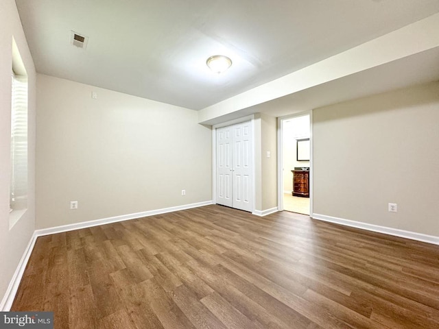 finished basement with dark wood-style flooring and baseboards