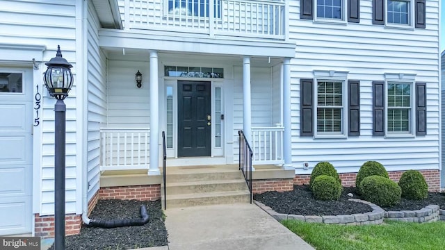 doorway to property featuring a balcony and a garage