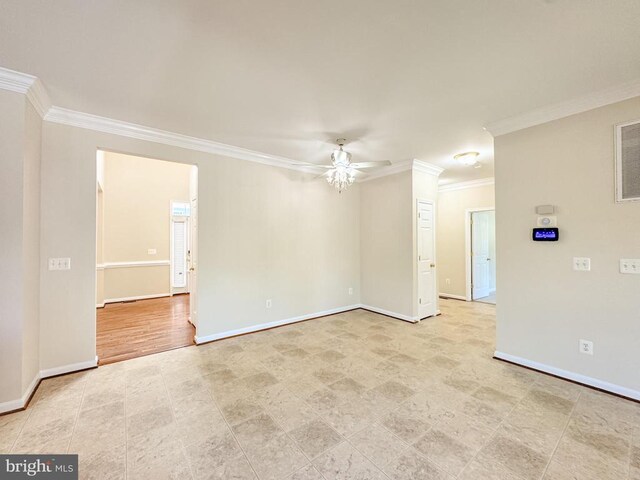 empty room featuring ornamental molding, a ceiling fan, and baseboards