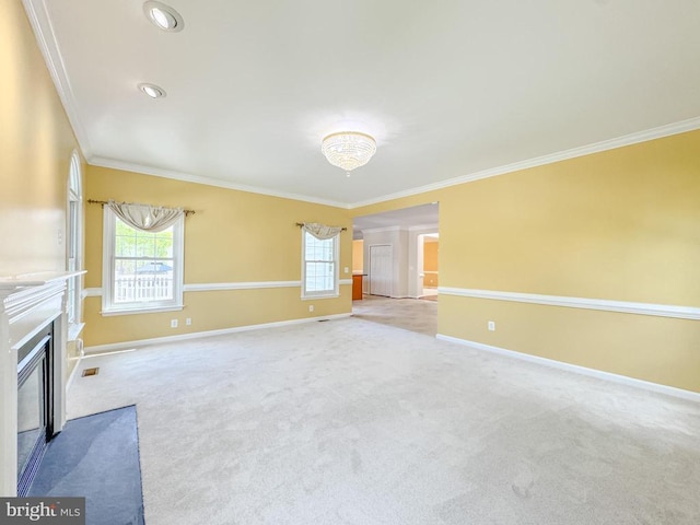 unfurnished living room with ornamental molding, carpet, a fireplace with flush hearth, and baseboards
