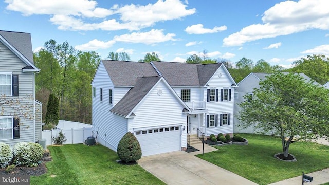 traditional home with a balcony, central AC, driveway, an attached garage, and roof with shingles