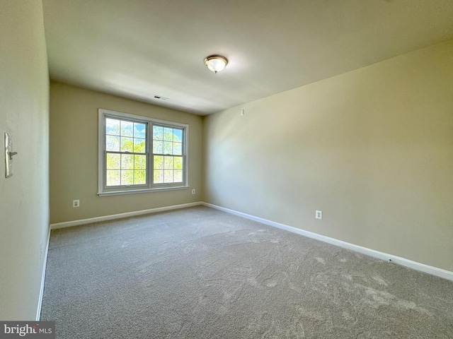 carpeted empty room with baseboards