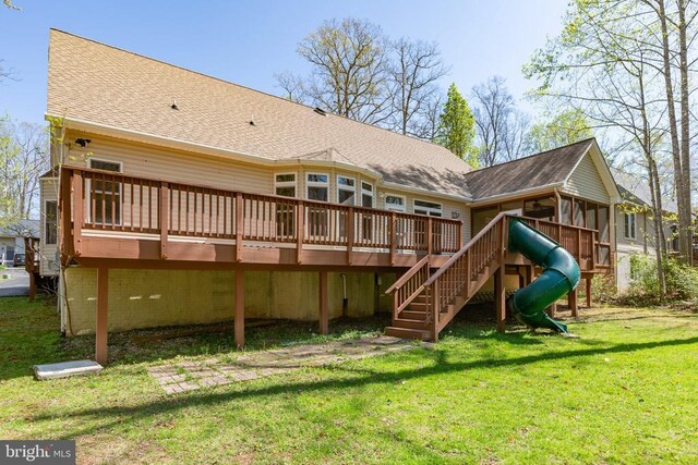 108 Monroe St, Locust Grove, VA 22508 - rear view of house featuring a sunroom, a shingled roof, a wooden deck, a lawn, and stairs