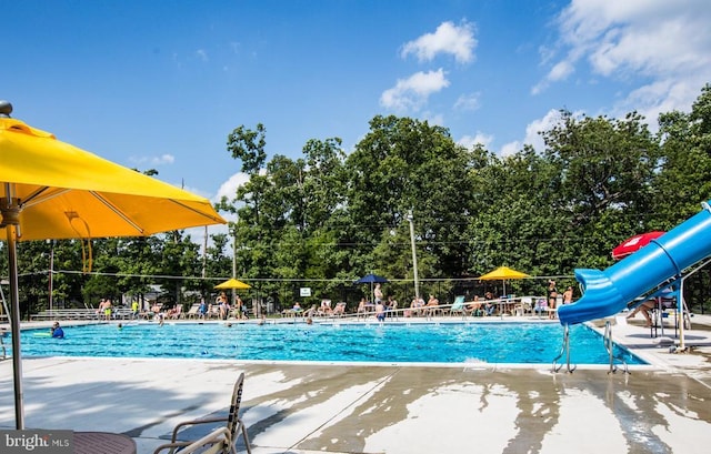 community pool featuring fence and a patio area