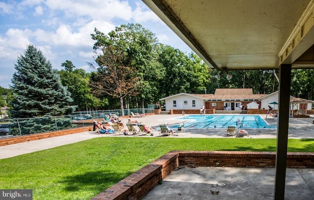 community pool featuring a patio area and view of scattered trees