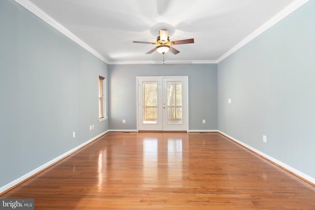 unfurnished room with ceiling fan, ornamental molding, wood finished floors, baseboards, and french doors