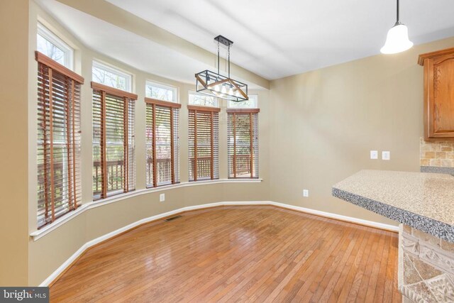 108 Monroe St, Locust Grove, VA 22508 - unfurnished dining area with light wood finished floors, baseboards, and a chandelier