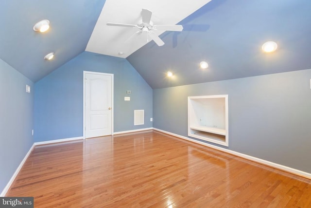 bonus room featuring ceiling fan, vaulted ceiling, wood finished floors, and baseboards