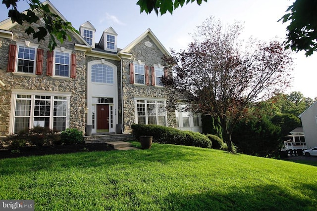  - view of front of house with stone siding and a front yard