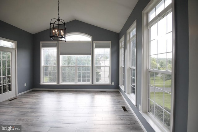  - unfurnished sunroom featuring vaulted ceiling and a chandelier