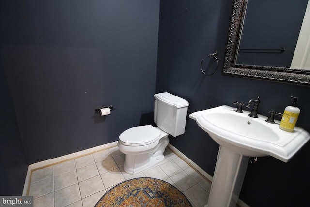  - half bathroom featuring baseboards and tile patterned floors