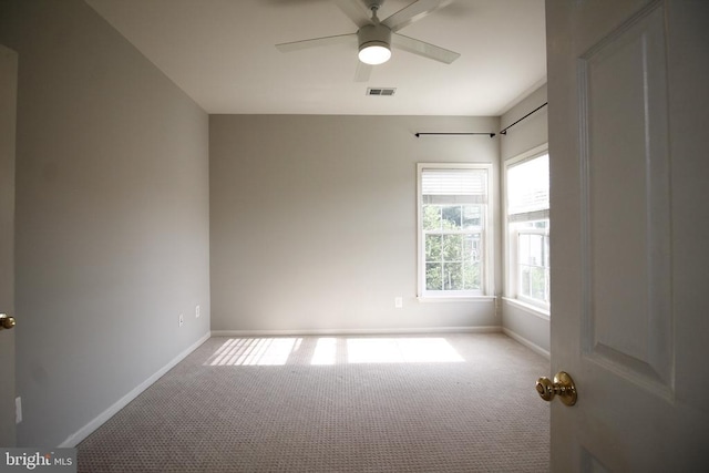  - carpeted spare room with baseboards and ceiling fan