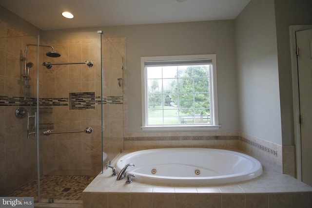 - bathroom featuring a shower stall, a jetted tub, and recessed lighting