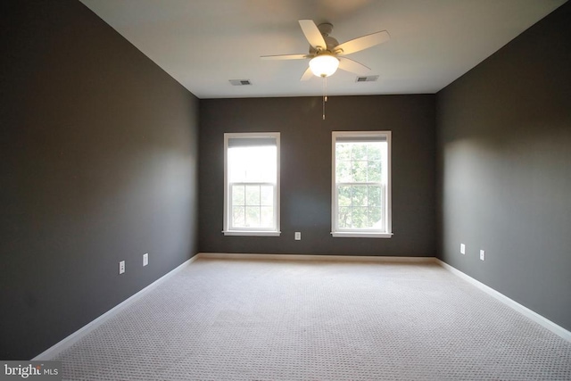  - spare room featuring light colored carpet and ceiling fan