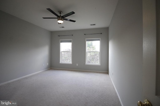  - carpeted spare room featuring baseboards and a ceiling fan