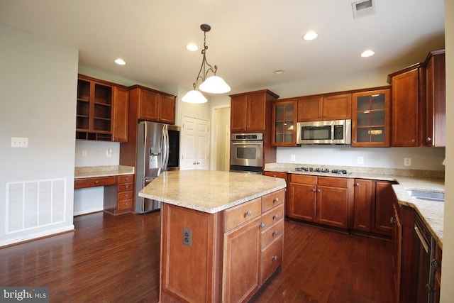  - kitchen featuring dark wood finished floors, a center island, light stone counters, appliances with stainless steel finishes, and recessed lighting