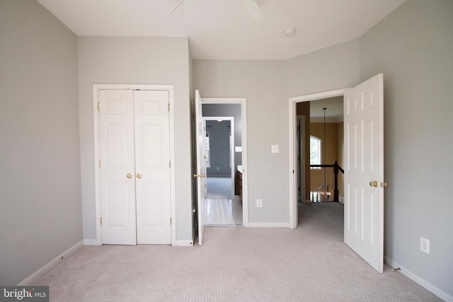  - unfurnished bedroom featuring light carpet and a closet