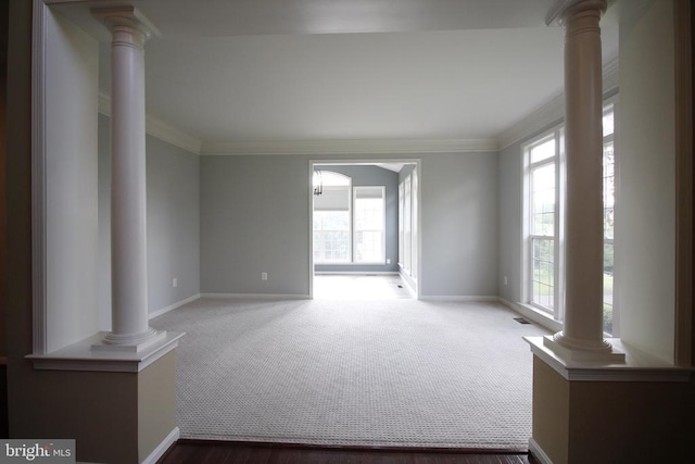  - unfurnished room with decorative columns, crown molding, and carpet floors