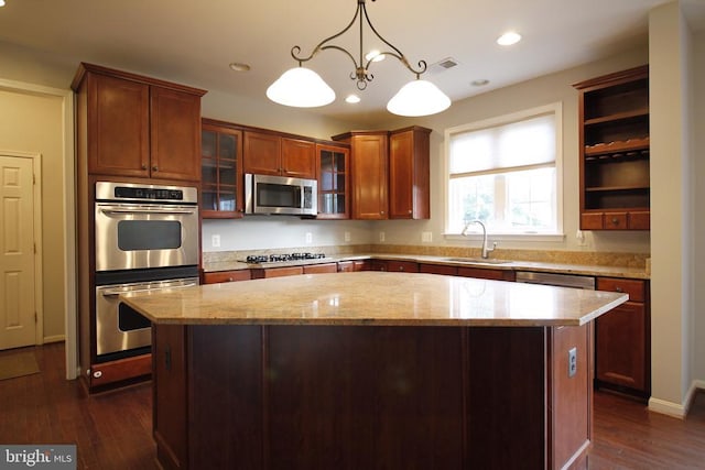  - kitchen featuring stainless steel appliances, a kitchen island, light stone countertops, glass insert cabinets, and open shelves