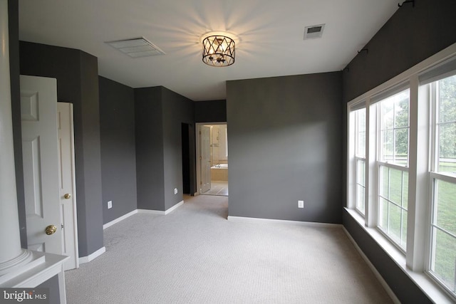  - unfurnished room with light carpet and baseboards