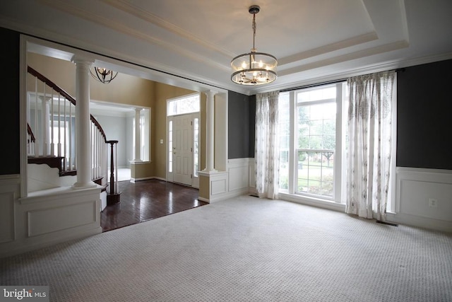  - carpeted entrance foyer with a decorative wall, decorative columns, wainscoting, a chandelier, and stairs