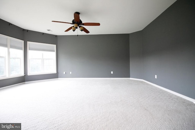  - carpeted spare room with ceiling fan and baseboards