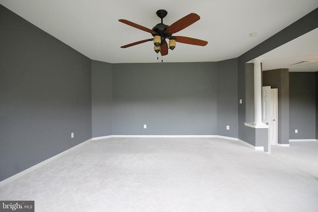  - carpeted empty room featuring ceiling fan and ornate columns