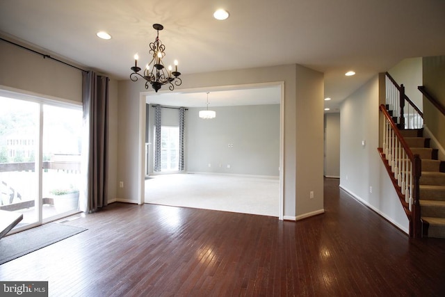  - empty room with a chandelier, healthy amount of natural light, hardwood / wood-style floors, stairway, and recessed lighting