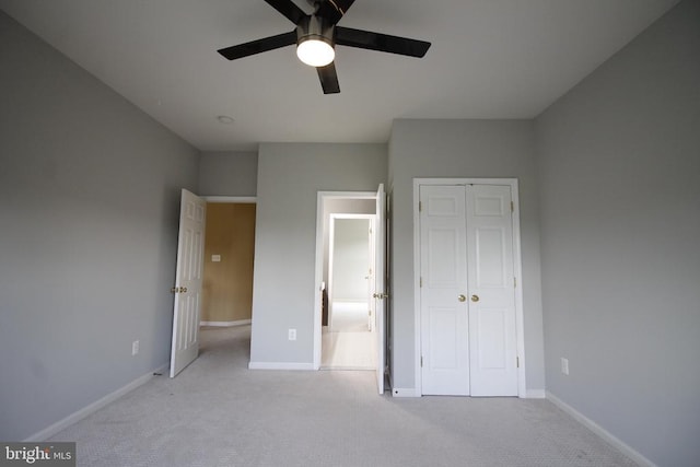  - unfurnished bedroom with light carpet, a closet, and ceiling fan