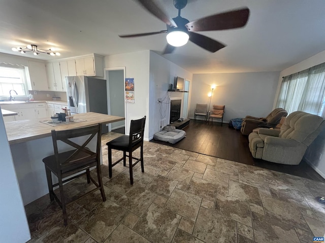 3133 Burnley Station Rd, Barboursville, VA 22923 - living area featuring stone tile flooring, baseboards, a ceiling fan, and a fireplace with raised hearth