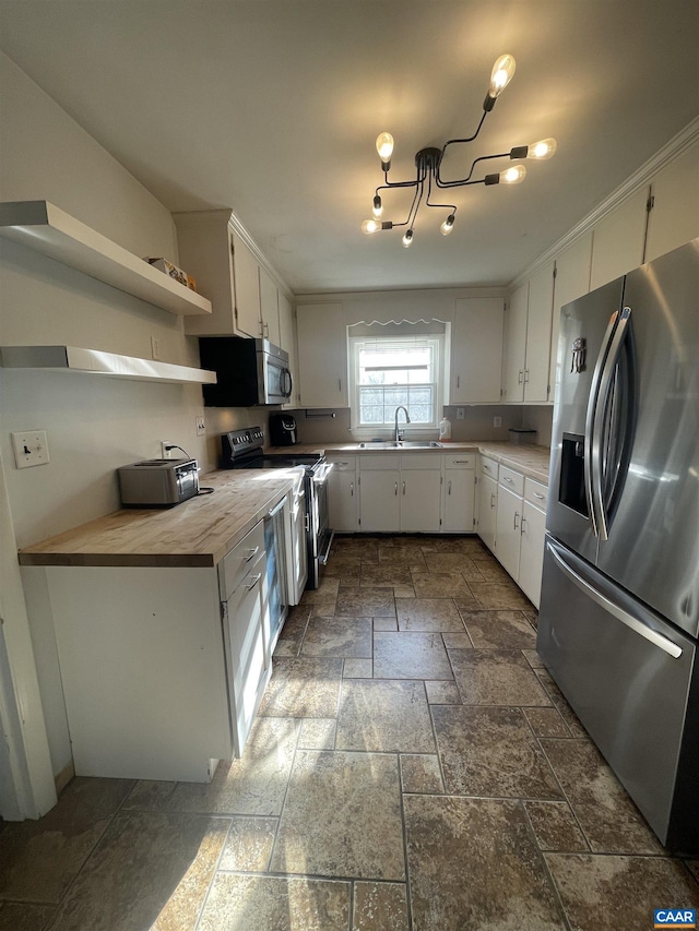 3133 Burnley Station Rd, Barboursville, VA 22923 - kitchen featuring stainless steel appliances, stone tile floors, a sink, and white cabinets
