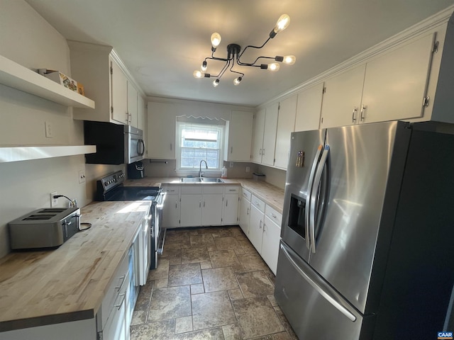 3133 Burnley Station Rd, Barboursville, VA 22923 - kitchen with appliances with stainless steel finishes, open shelves, stone finish floors, a sink, and light countertops