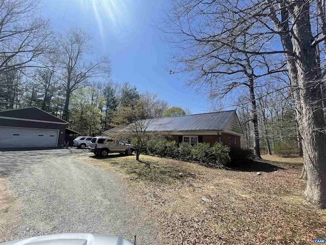 3133 Burnley Station Rd, Barboursville, VA 22923 - view of home's exterior featuring driveway, an outdoor structure, and metal roof